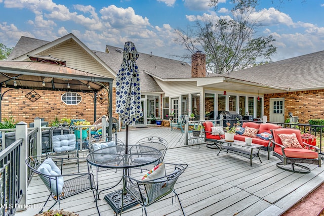 wooden terrace with outdoor lounge area