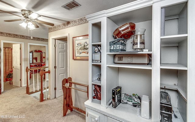 corridor featuring a textured ceiling and light colored carpet