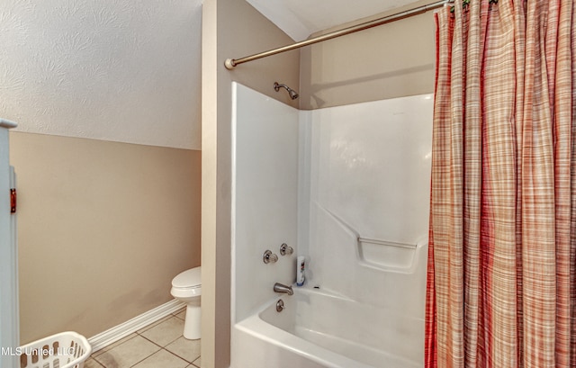 bathroom featuring shower / bath combo with shower curtain, tile patterned flooring, and toilet