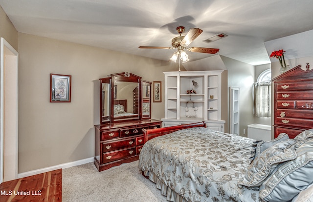 bedroom featuring light hardwood / wood-style flooring, ceiling fan, and ensuite bath