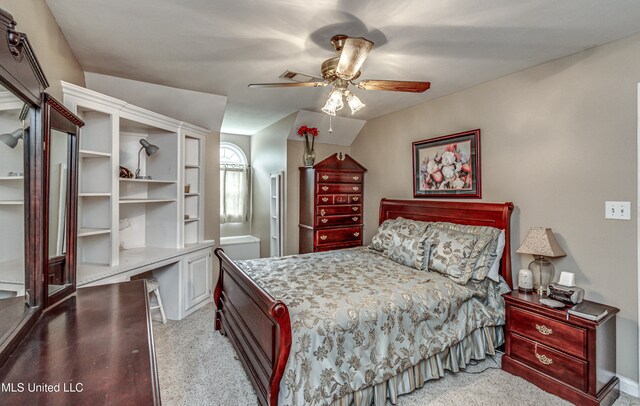 carpeted bedroom featuring ceiling fan and vaulted ceiling