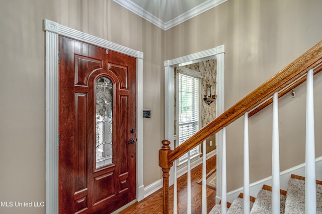 foyer with ornamental molding and hardwood / wood-style floors