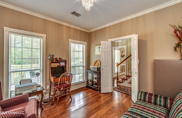 sitting room with dark wood-type flooring, a healthy amount of sunlight, and crown molding