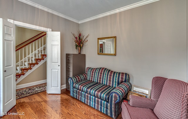 sitting room with hardwood / wood-style flooring and crown molding