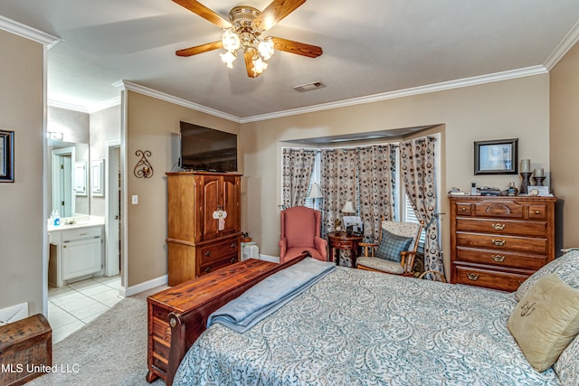 bedroom featuring ornamental molding, light tile patterned floors, ceiling fan, and ensuite bath