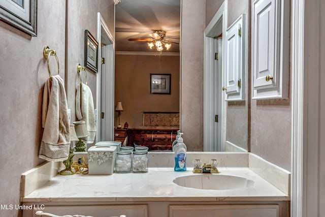 bathroom featuring ceiling fan, vanity, and crown molding