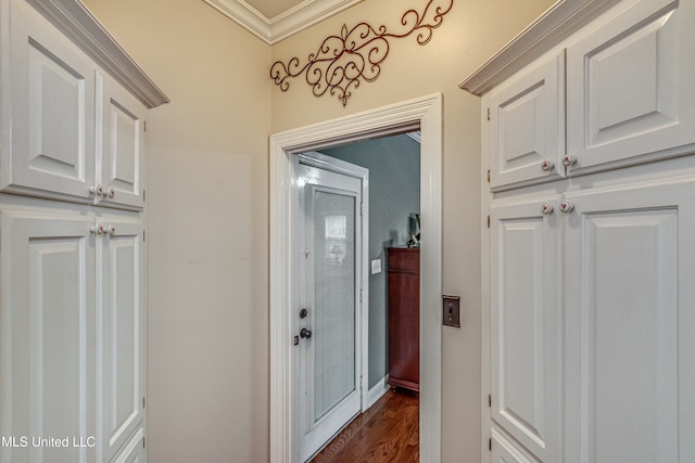 hallway with ornamental molding and dark hardwood / wood-style flooring