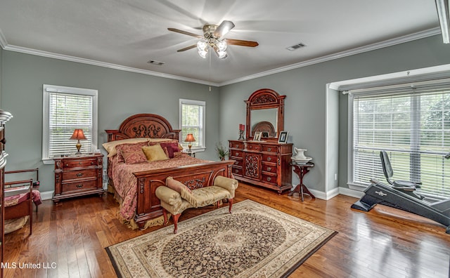 bedroom with dark hardwood / wood-style flooring, ornamental molding, multiple windows, and ceiling fan