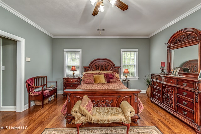 bedroom featuring ornamental molding, hardwood / wood-style floors, multiple windows, and ceiling fan