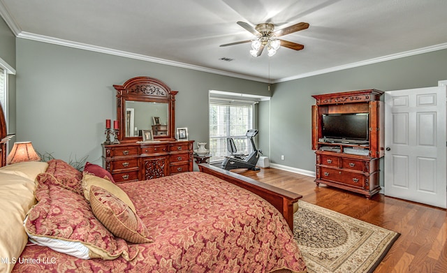 bedroom with hardwood / wood-style floors, ceiling fan, and crown molding