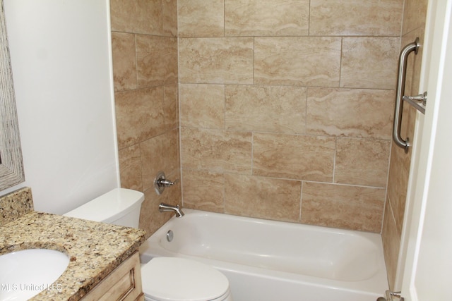 full bathroom with toilet, vanity, and tiled shower / bath