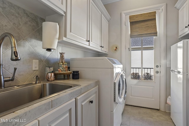 washroom with washer and dryer and a sink