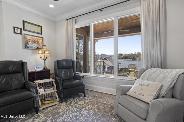 sitting room featuring dark wood-style floors, crown molding, recessed lighting, a water view, and baseboards