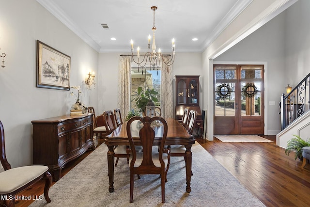 dining room featuring ornamental molding, french doors, dark wood finished floors, and stairs