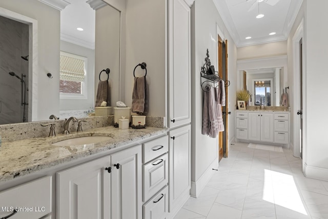 bathroom featuring ornamental molding, two vanities, a sink, and recessed lighting