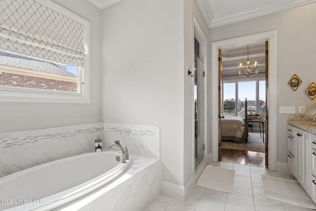 ensuite bathroom with a garden tub, crown molding, an inviting chandelier, connected bathroom, and vanity