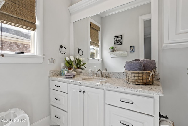 bathroom with vanity and baseboards