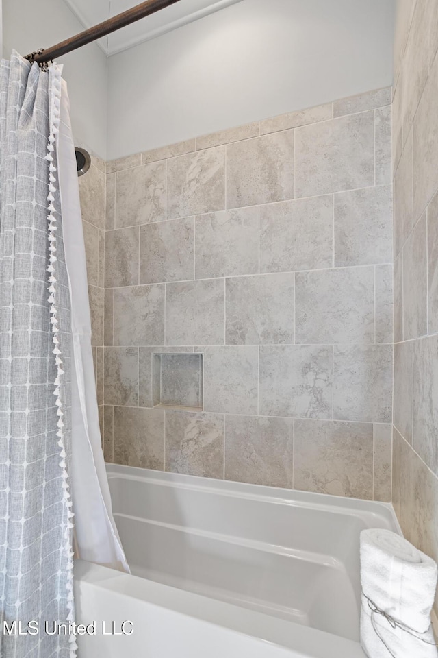 bathroom with shower / bath combo with shower curtain