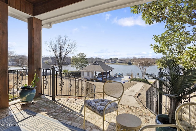 view of patio / terrace featuring a water view, a balcony, and a gazebo