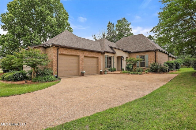 407 Belle Pointe Ln, Madison, MS 39110 - french country home with an attached garage, brick siding, concrete driveway, a shingled roof, and a front yard
