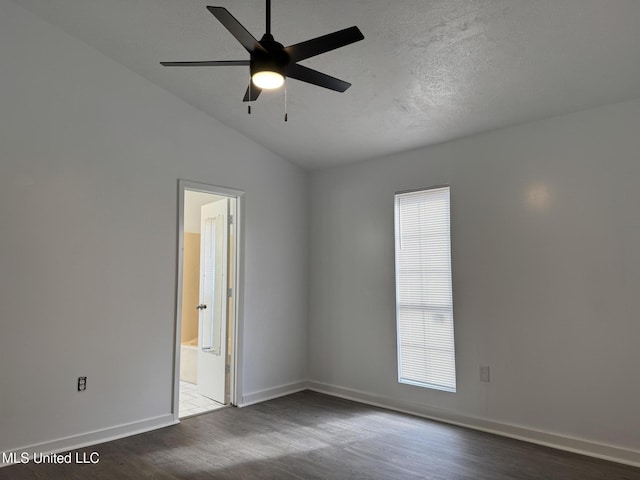 unfurnished room featuring ceiling fan, lofted ceiling, dark hardwood / wood-style floors, and plenty of natural light