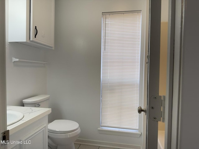 bathroom with vanity, toilet, and tile patterned flooring