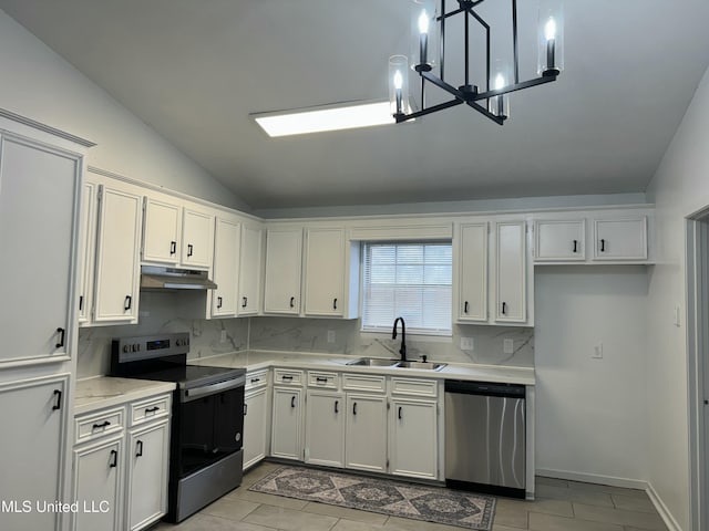 kitchen with white cabinetry, appliances with stainless steel finishes, sink, and lofted ceiling