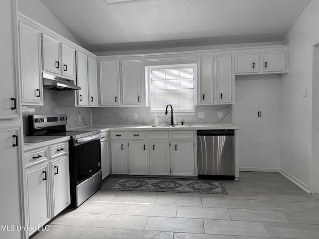 kitchen featuring lofted ceiling, sink, white cabinets, and appliances with stainless steel finishes