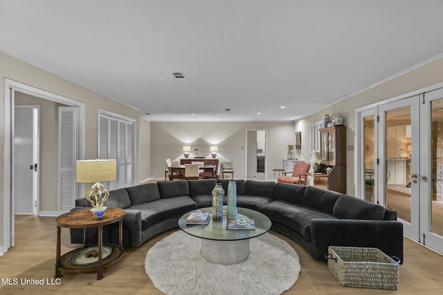 living room with french doors and light hardwood / wood-style flooring