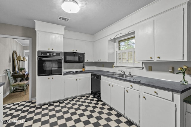 kitchen featuring white cabinets, black appliances, a textured ceiling, and sink