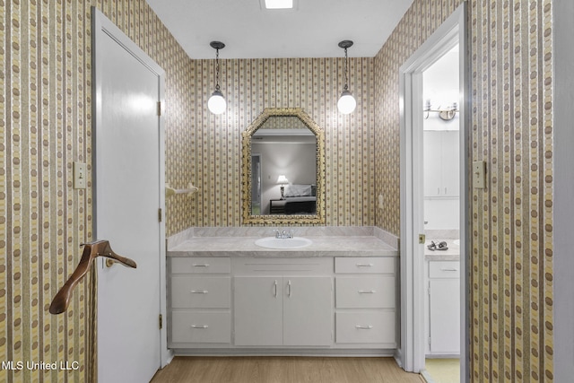 bathroom with hardwood / wood-style floors and vanity