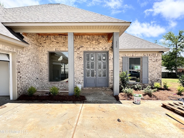 652 Prosperity Pl, Brandon, MS 39042 - entrance to property featuring brick siding, a shingled roof, and covered porch