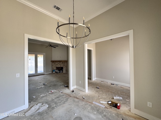 652 Prosperity Pl, Brandon, MS 39042 - unfurnished dining area featuring a chandelier, crown molding, ceiling fan, a fireplace, and french doors
