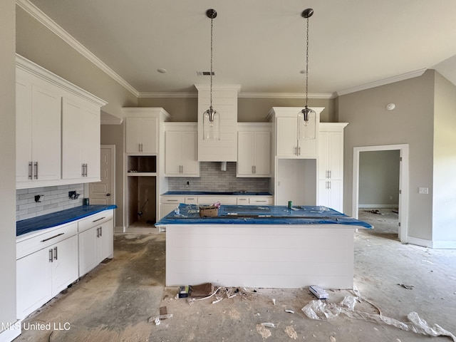652 Prosperity Pl, Brandon, MS 39042 - kitchen with a center island, tasteful backsplash, white cabinetry, crown molding, and decorative light fixtures