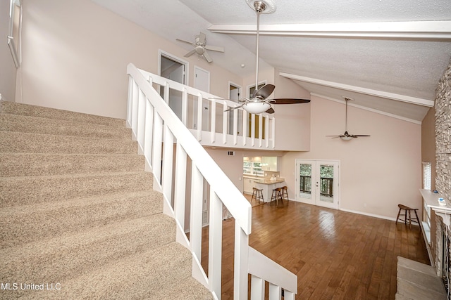 stairway featuring a textured ceiling, french doors, ceiling fan, and beam ceiling