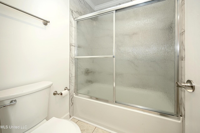 bathroom featuring shower / bath combination with glass door, toilet, and tile patterned floors