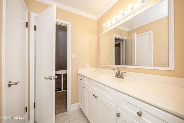 bathroom featuring tile patterned flooring, crown molding, and vanity