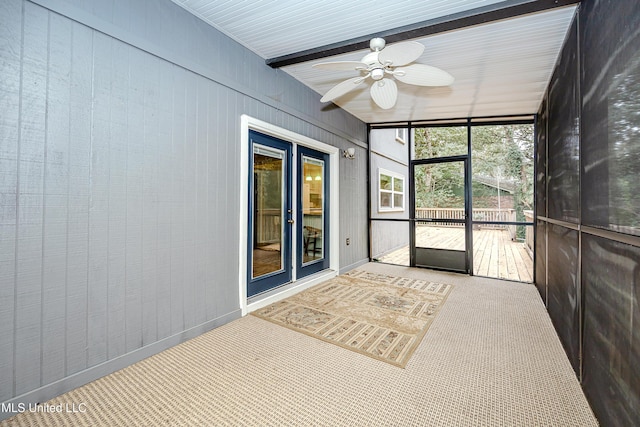 unfurnished sunroom with ceiling fan