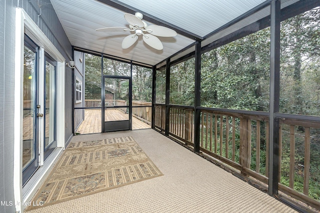 unfurnished sunroom featuring ceiling fan