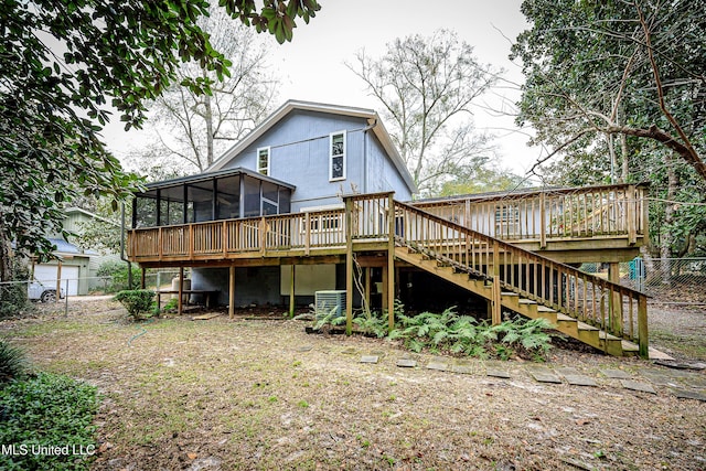 back of house featuring central air condition unit, a deck, and a sunroom