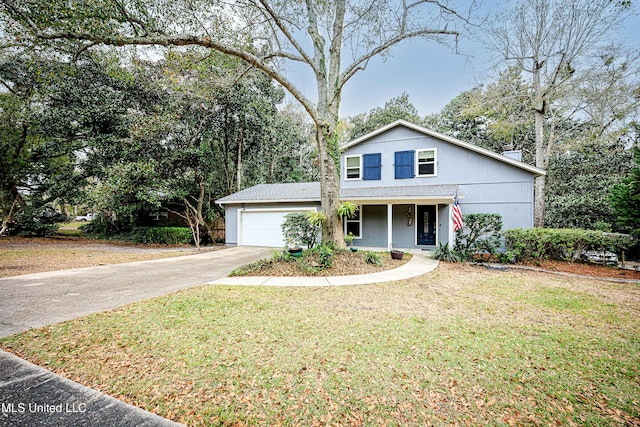 front of property featuring a front yard, a garage, and covered porch