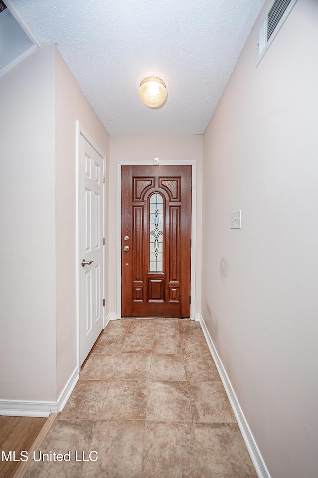 entryway featuring a textured ceiling