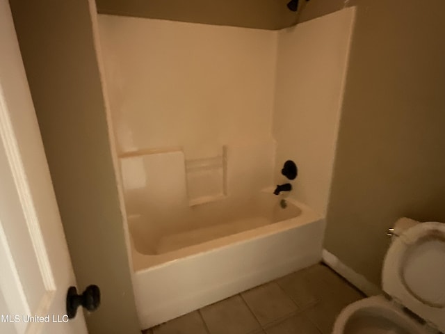 full bath featuring tile patterned floors, toilet,  shower combination, and baseboards