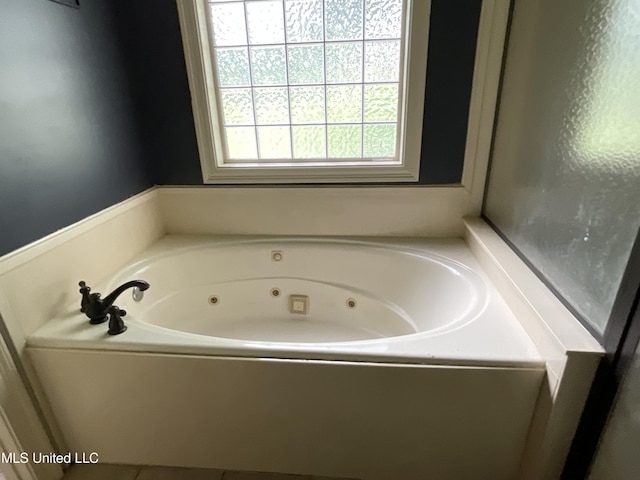 full bathroom with a tub with jets