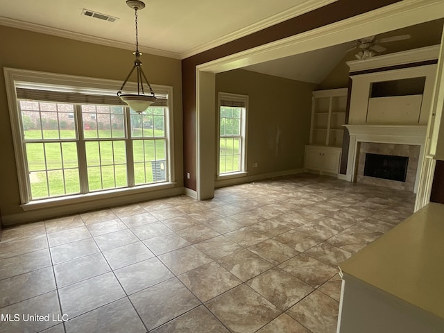 unfurnished dining area with baseboards, ornamental molding, a fireplace, and lofted ceiling