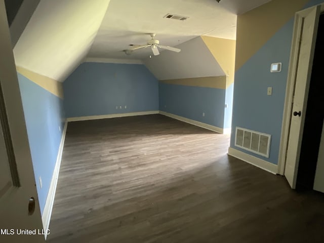 bonus room featuring dark wood-type flooring, baseboards, lofted ceiling, and a ceiling fan