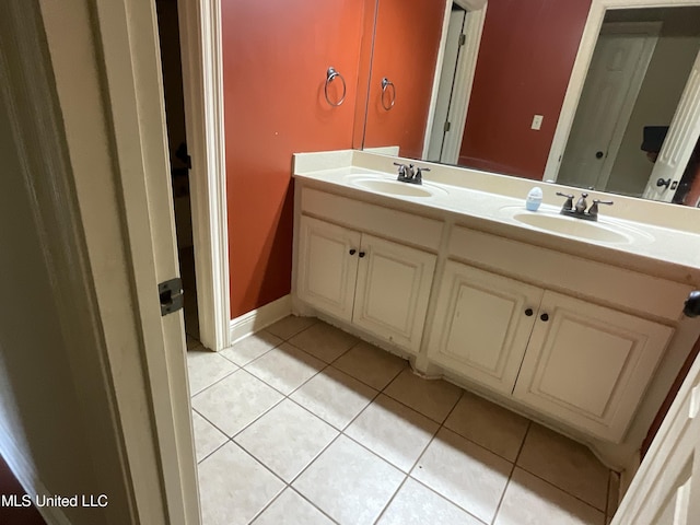 full bathroom with tile patterned floors, double vanity, and baseboards