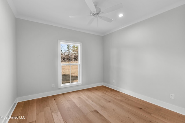 spare room featuring light wood-style floors, baseboards, and a ceiling fan