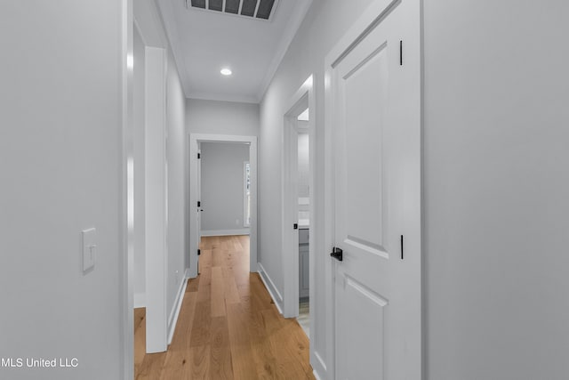 hall featuring recessed lighting, visible vents, light wood-style floors, ornamental molding, and baseboards