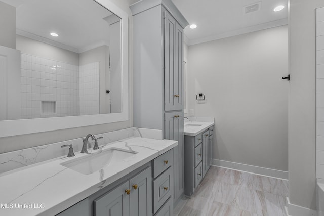 full bath featuring ornamental molding, a sink, and visible vents